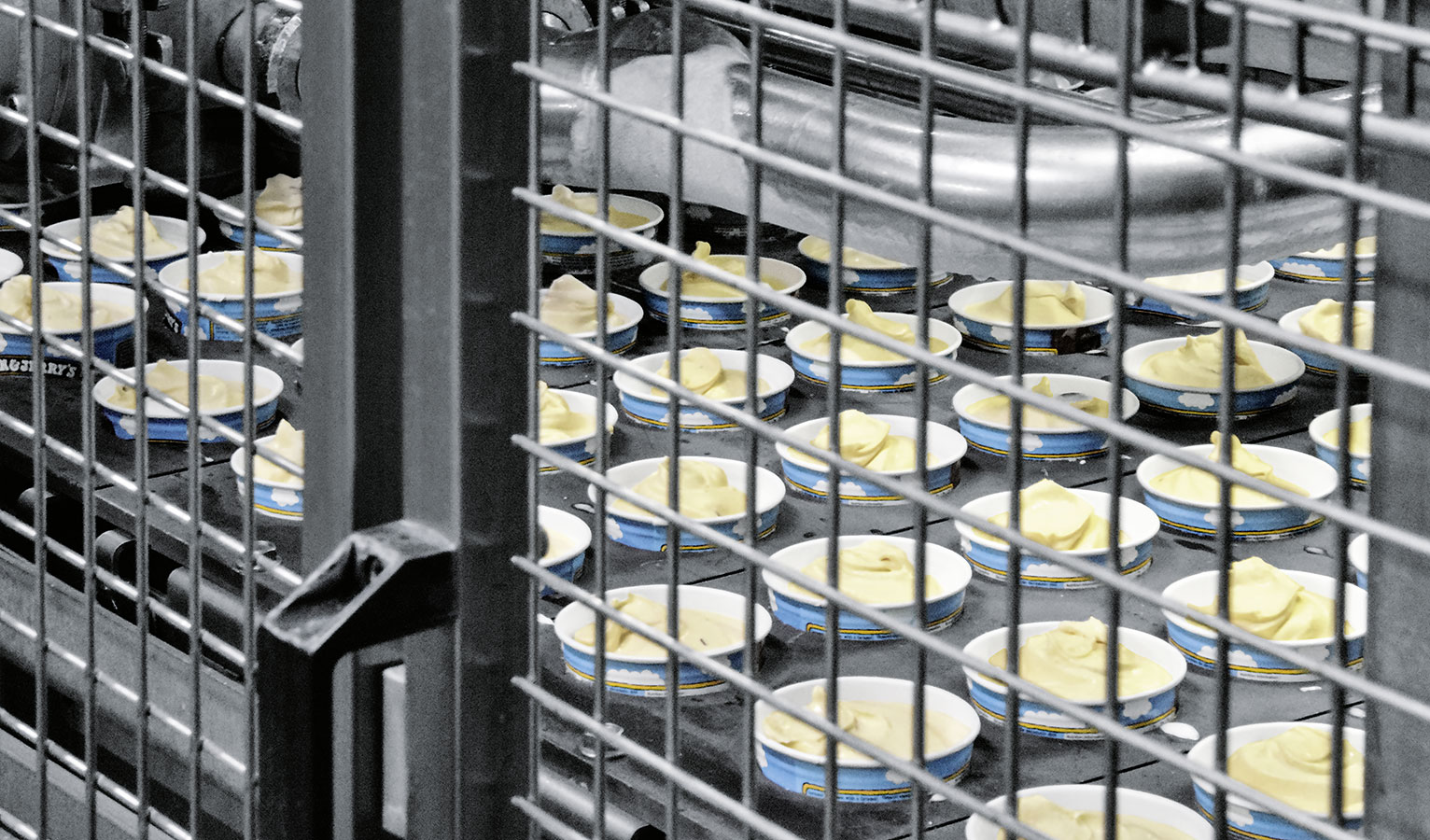 Compressed air is used to de-stack the cups and fill them with the ice cream.
