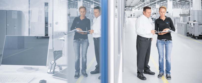 Industrial Internet of Things Technologies: Worker Speaks with Coworkers in Production Hall