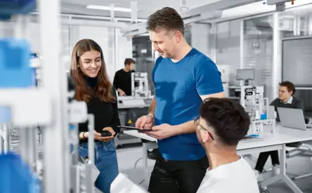 teacher with students in modern automation lab