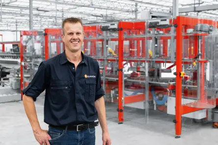 John Van de Ven, the founder of Aventec, in front of his rose cutting machine