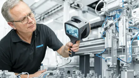 Man with leakage detection device to find leakages in production