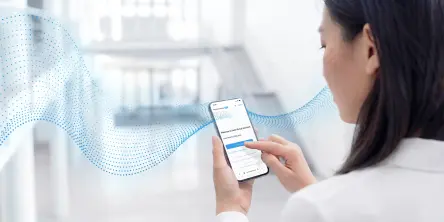 A woman uses the Festo Virtual Assistant on her smartphone in an office setting to get quick product information.