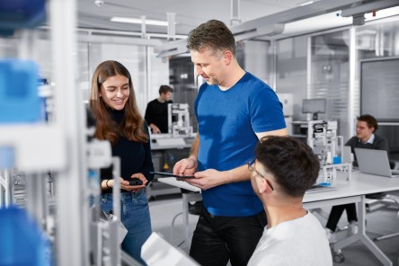 teacher with students in modern automation lab