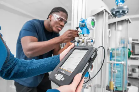 Student calibrating a smart field device on the DCS learning system