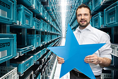 Empleado en un almacén de Festo sostiene una estrella azul